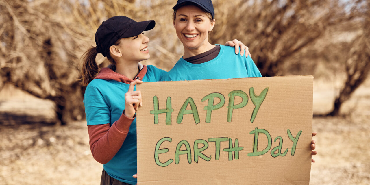 mother and daughter holding an Earth Day sign